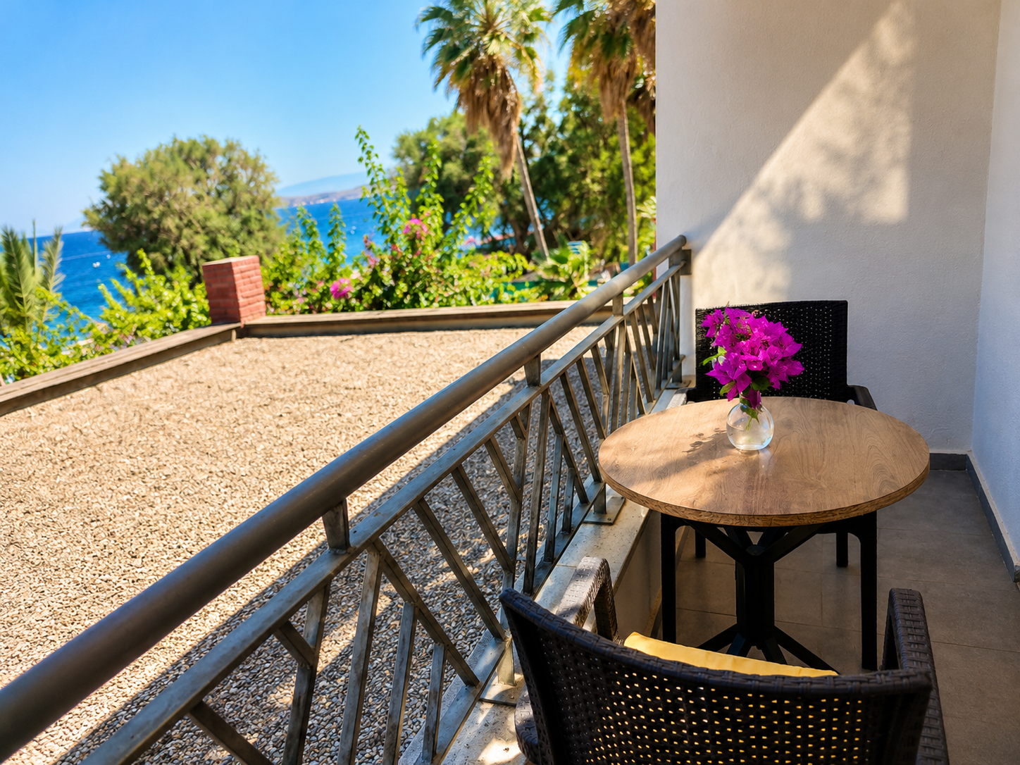 Private balcony with sea view and palm trees