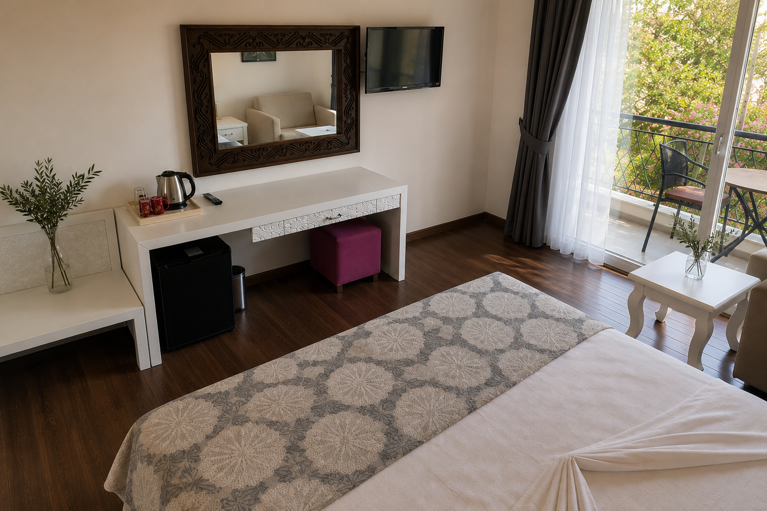 Deluxe room interior with desk, television, and balcony