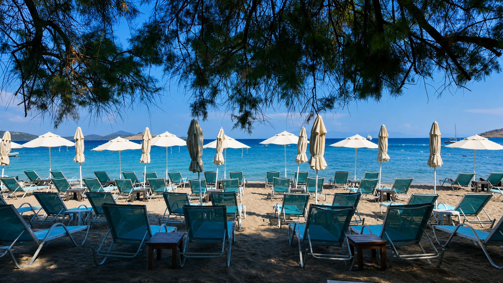 Bare feet on wooden planks at the edge of crystal-clear turquoise water