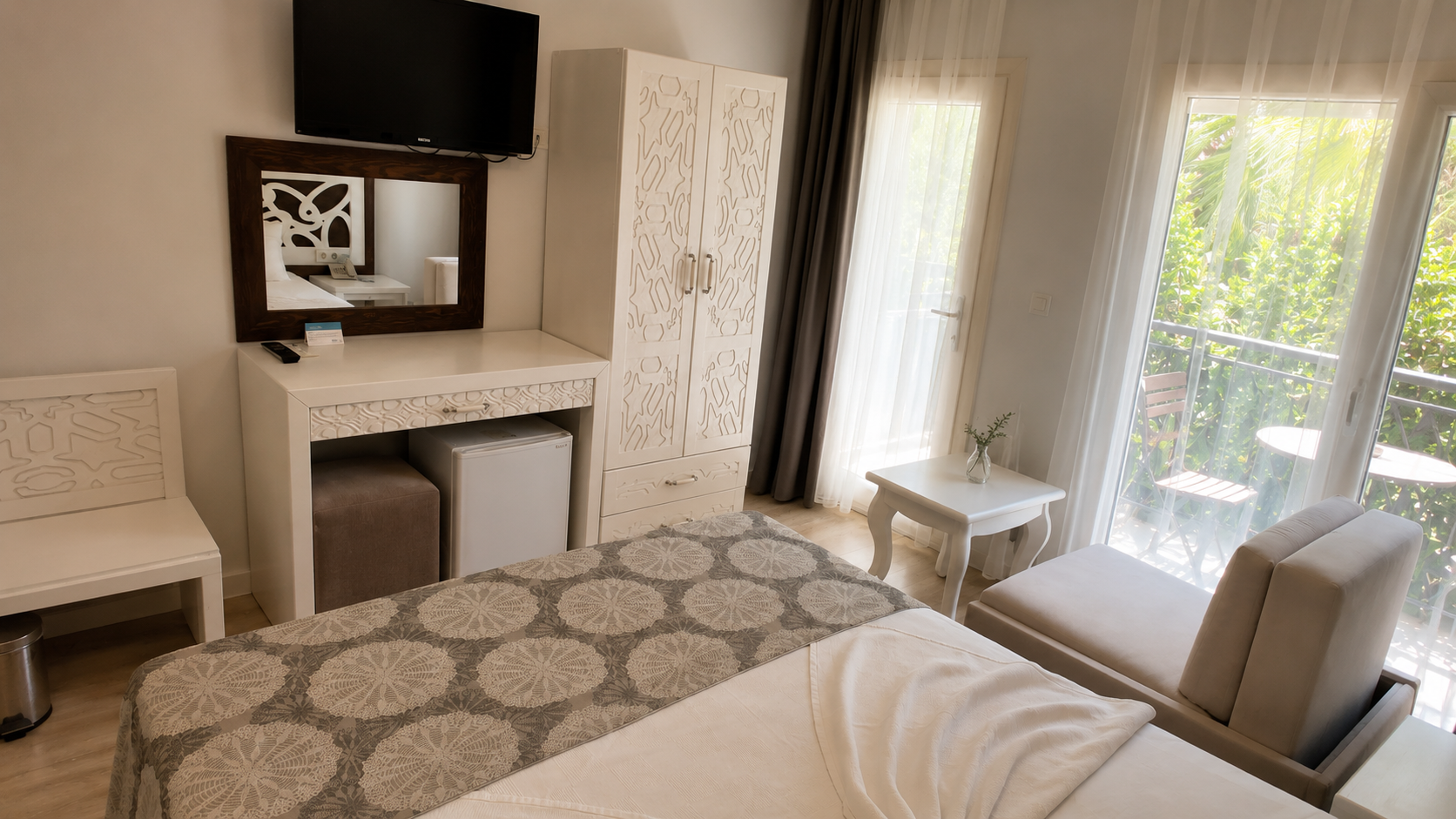Standard room interior with wardrobe and balcony doors